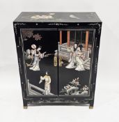 Chinese black lacquered cabinet with painted decoration of figures, birds and flowers, the two doors