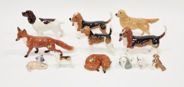 Two Beswick model Bassett hounds, Beswick model fox standing and another lying and curled up, and