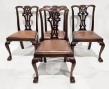 Set of four mahogany dining chairs in the George III manner, with carved pierced splats, drop-in