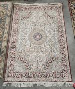 Kashmir cream ground silk rug, with central circular floral medallion on woven floral field and
