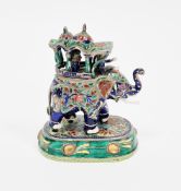 Miniature white metal and enamelled model of an Indian elephant carrying a howdah with two