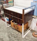 Shop counter-type display cabinet with glazed top and polished metal and wooden-effect frame, the