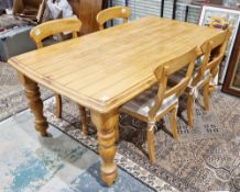 French style hardwood dining room table with plank effect top and raised on substantial turned