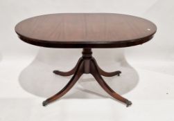 Reproduction mahogany veneer extending D-end dining table on brass lion paw feet and castors, 78cm