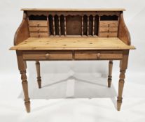 Pine desk, the upper section with an arrangement of small drawers and pigeonholes over a base with