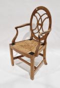 Pale ash and beech elbow chair in the Sheraton manner, the oval back with interseptant seat scroll