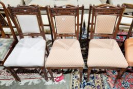Set of three late Victorian walnut dining chairs, the carved back rail including mythical