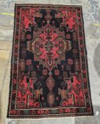 Fine Afghan Belouchi rug, 100% wool, black background with unusual borders and centre piece with