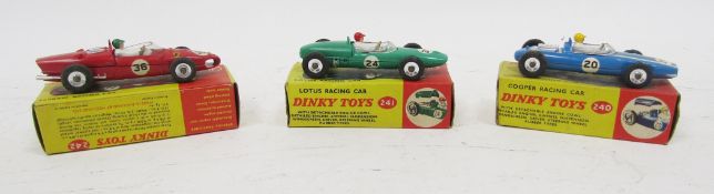 Three boxed Dinky Toys diecast racing cars including 240 Cooper racing car, 241 Lotus racing car and