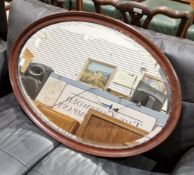Early 20th century mahogany-framed oval mirror with a bevelled edge