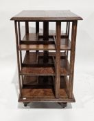 Early 20th century oak square revolving bookcase raised on castors, 53cm wide x 87cm high