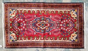 Highest quality hand knotted Iranian rug in reds, greens, light blue, brown, creams and coral to a