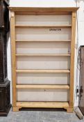 Large open pine bookcase with six shelves, raised on bracket feet (open back), 130cm wide x 29cm