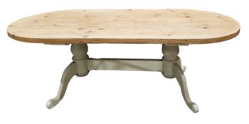 Substantial pine oval dining room table raised on a painted base of twin pedestals, each with two