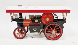 Scratch-built live steam metal scale model of a traction engine, red and black with a red and