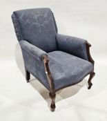 Early 20th century armchair with blue floral embossed upholstery and raised on front cabriole