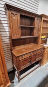 Late 19th/early 20th century oak dresser in the Jacobean manner, the upper section with two