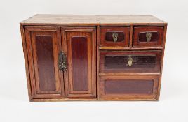 20th century Chinese hardwood collectors cabinet having two door cupboard, three drawers and a false