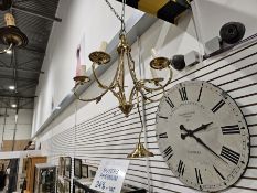 A contemporary gilt-metal five-light chandelier, with foliate s-shaped branches, suspended from a
