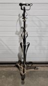 A late 19th/early 20th century telescopic standard lamp scrolling decoration raised on tripod base