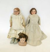 Diamond Pottery Co. bisque doll's head with painted blue eyes and mouth, impressed mark D.P.Co