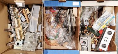 Collection of model railway 00 and H0 gauge layout accessories including buildings, track, packet