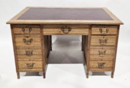 Victorian oak twin-pedestal desk with burgandy leather inset top over an arrangement of nine drawers