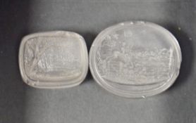 Two 19th century rock crystal seals, both with carved with hunting scenes, one oval 3.4cm long and