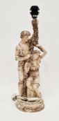 Academy resin table lamp in the form of a scantily clad man and woman by a garland of leaves, 64cm