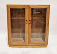 Ercol pale blonde elm windsor glazed bookcase/display cabinet, model 810, with two glazed doors