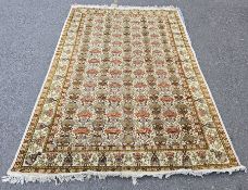 Large Persian style cream ground rug with floral field with repeating urn pattern, multiple floral