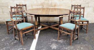 Ercol dining room suite comprising a dark stained elm top extending oval dining table, 163cm long (