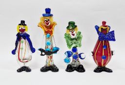 Four Murano glass figures of clowns, one with a baluster ruby and yellow striped case body,