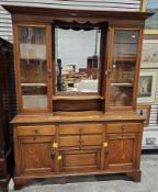 Late 19th century oak dresser, the mirrored back flanked by two glazed cupboards opening to fixed