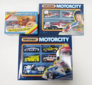 Three boxed Matchbox 'Motorcity' diecast vehicle gift sets including set MC9 Goodyear racing
