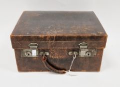 Late 19th/early 20th century leather travelling dressing case, the hinged lid opening to a green