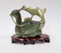 Chinese carved spinach jade model of a mandarin duck, 10cm high x 9.5cm wide and the carved hardwood