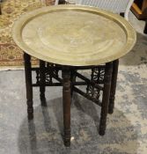 Eastern brass circular tray on wooden turned supports to make a table