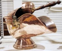 Arts & Crafts-style hammered copper coal scuttle with fitted coal shovel