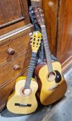 Two guitars, one labelled Cleca model DAG-IN-36 made in China, the other larger labelled inside