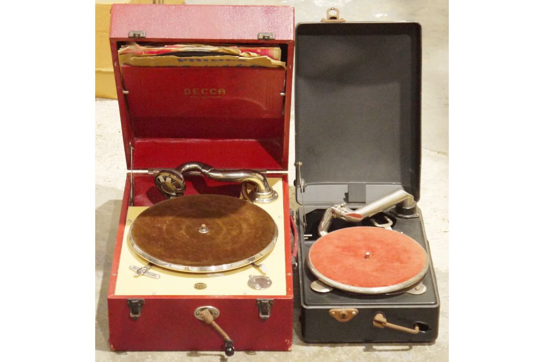 Two portable wind-up gramophones including a red cased Decca 50 gramophone and a black metal cased