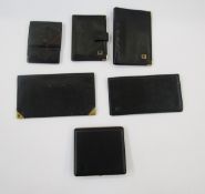 Assorted Dunhill black leather wallets and a cigarette case, with gilt metal detail and stamped logo