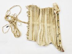 An Edwardian corset, metal stays, cream broderie anglaise over cotton, with lace and ribbon trim