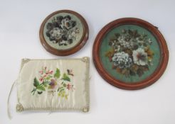 Two Victorian beadwork panels, mounted within circular wood frames, one on three raised bun feet