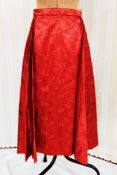 A 1950's red figured satin 'swing' skirt, full circle with side pleats, small waist