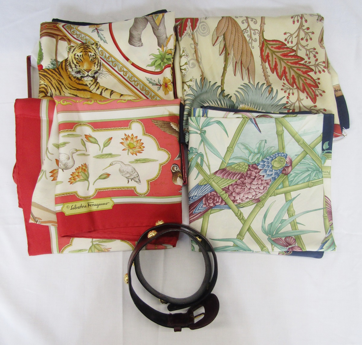 Salvatore Ferragamo - four various silk scarves and one original box, the scarves designed with
