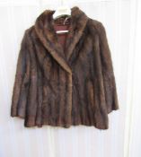 A vintage musquash jacket, embroidered name framed in laurel leaves in satin lining