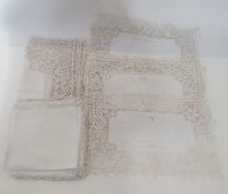 A linen tableware set of lace mats, linen napkins and small square table cloth