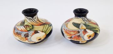 Pair of Moorcroft pottery vases of squat baluster form with tube lined decoration of koi carp on