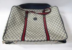 Gucci suitcase, with inside pocket and straps, 'Gucci, Made in Italy' label inside, 60cm long x 42cm